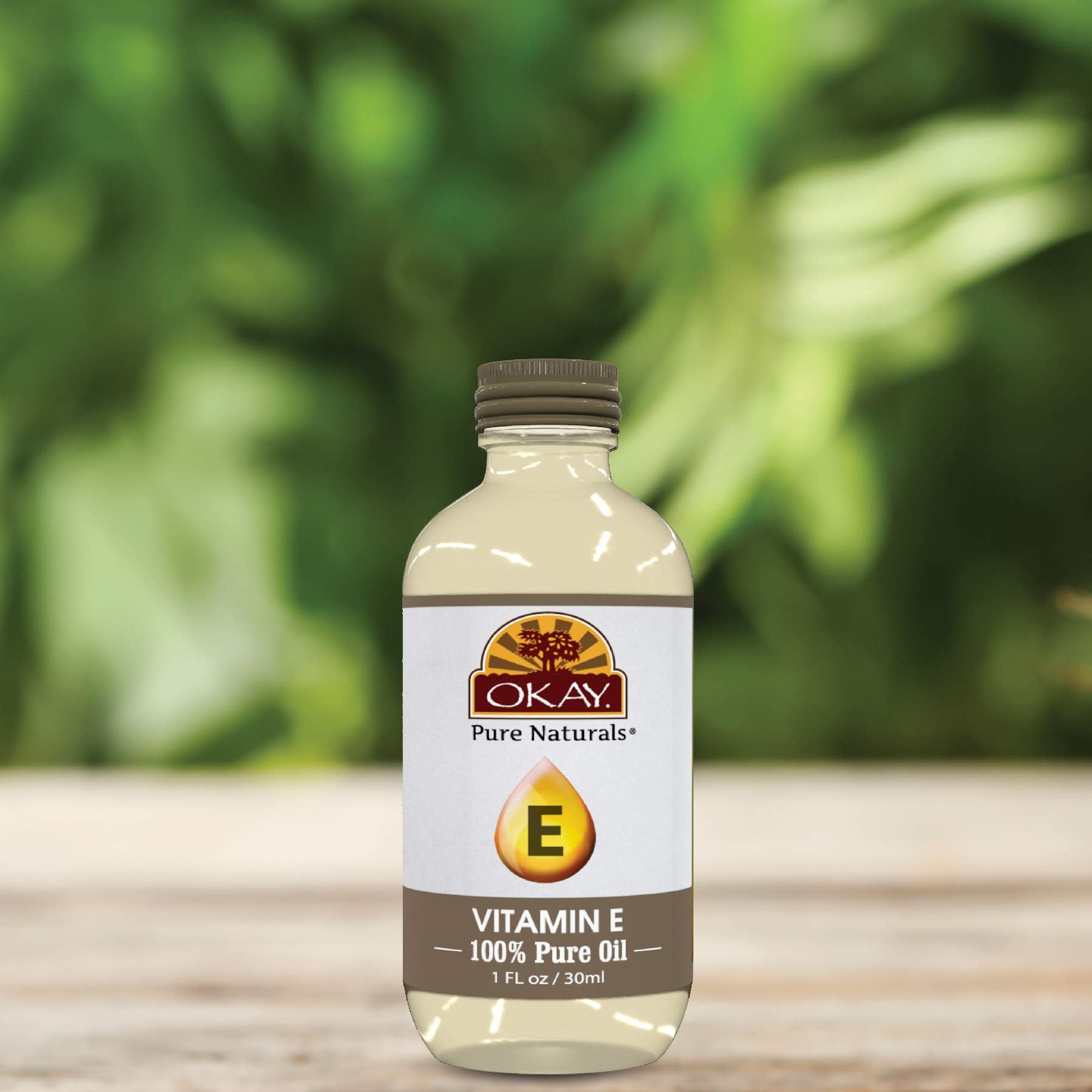 OKAY Vitamin E Oil texture close-up shows smooth, easy-massage consistency.
