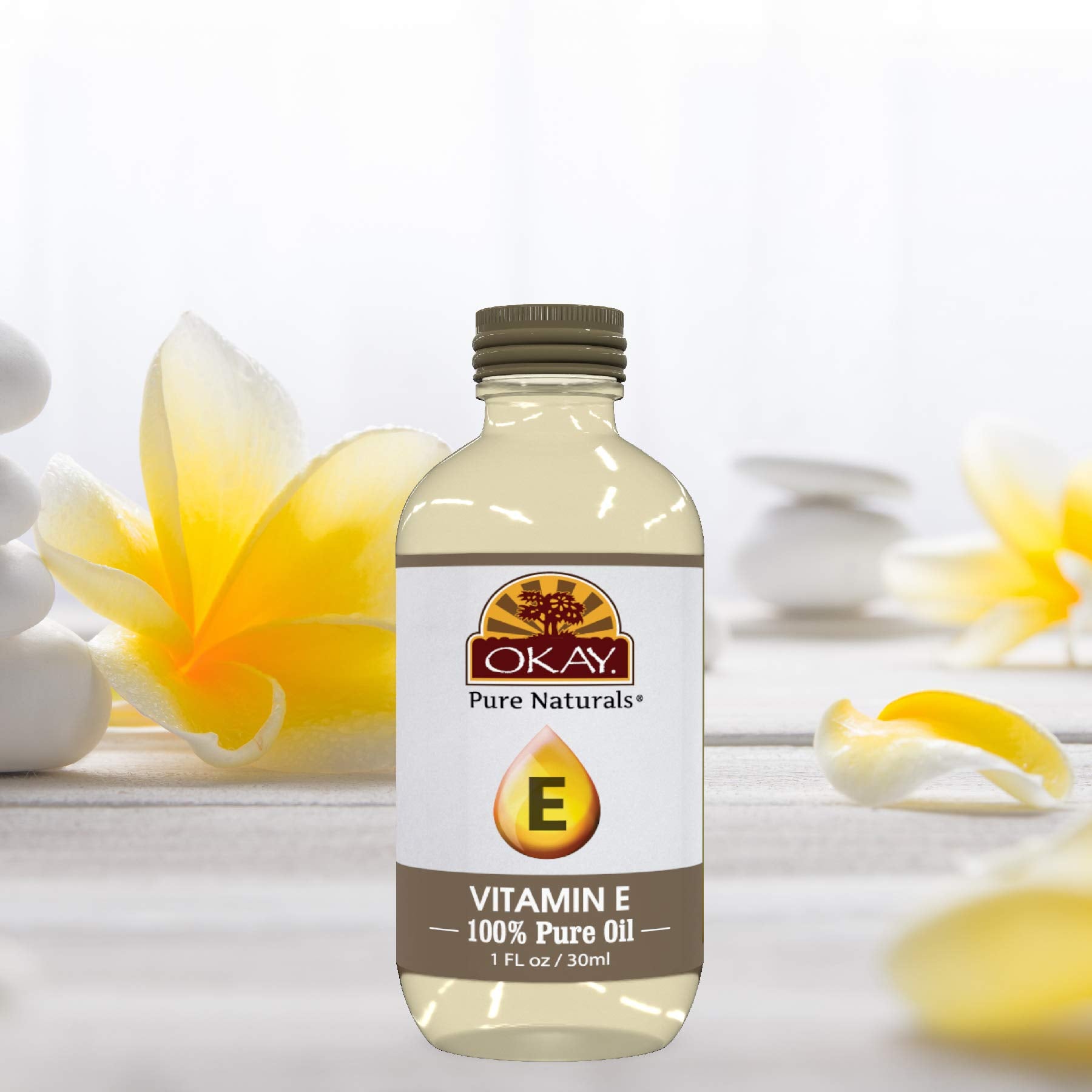 OKAY Vitamin E Oil close-up highlights pure amber oil and emollient richness.
