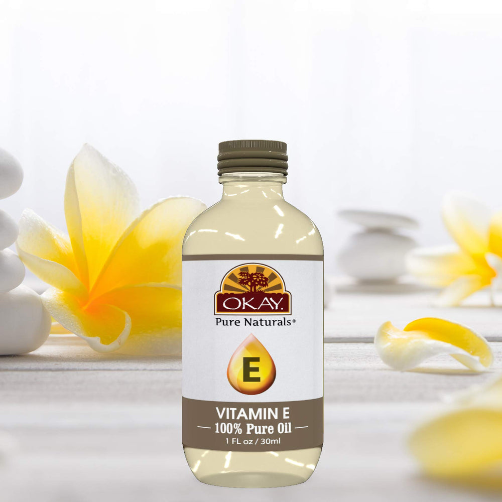 OKAY Vitamin E Oil close-up highlights pure amber oil and emollient richness.