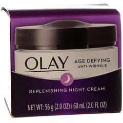 Bottle of Olay night cream on skin illustrating nighttime hydration.