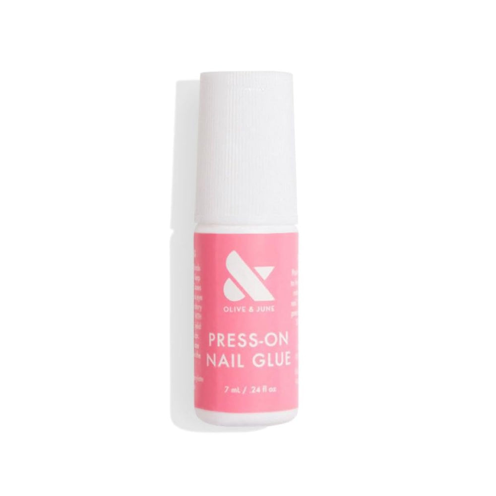 Olive & June brush-on glue bottle for precise, mess-free nail adhesion.