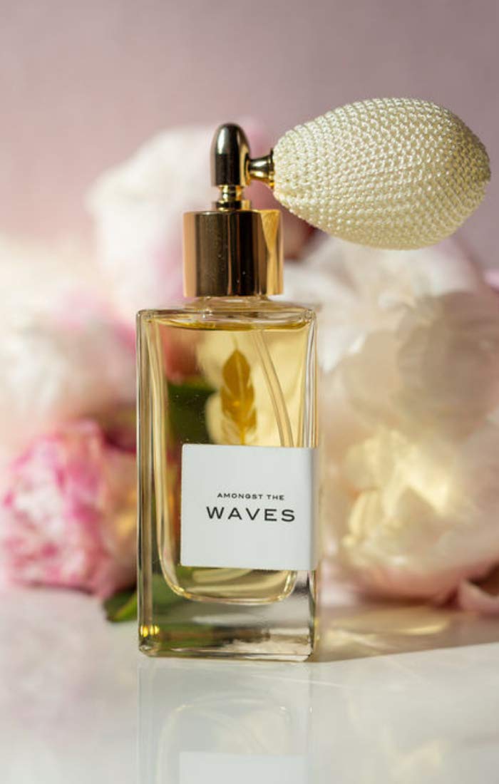 Olivine Atelier Amongst the Waves bottle close-up, lily and coconut on display for tropical vibes.