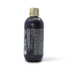 Hands apply O&M Frizzy Logic Serum to damp hair