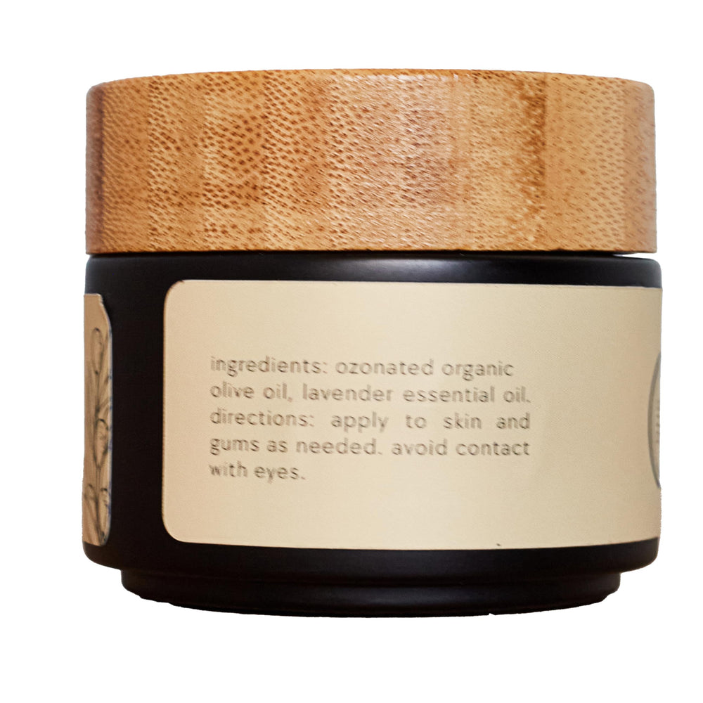 ONE11 ozonated olive oil bottle closeup emphasizes a pure two-ingredient formula.