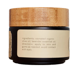ONE11 ozonated olive oil bottle closeup emphasizes a pure two-ingredient formula.
