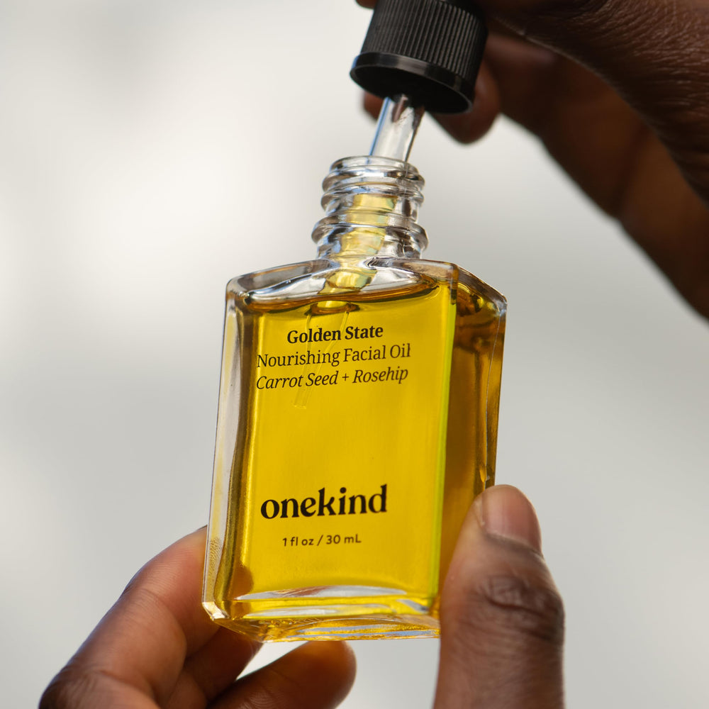 Onekind Golden State hand with oil texture demonstrating non-greasy hydration.