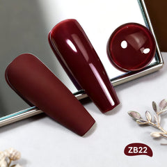 Close-up of the OpenLive brush applying quick-dry dark red polish.