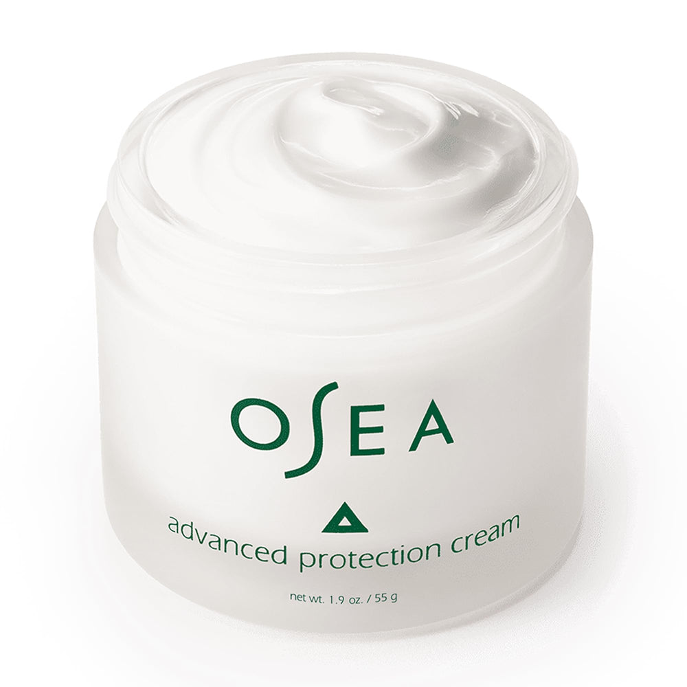 Hands applying OSEA Advanced Protection Face Cream, ready for daily use.