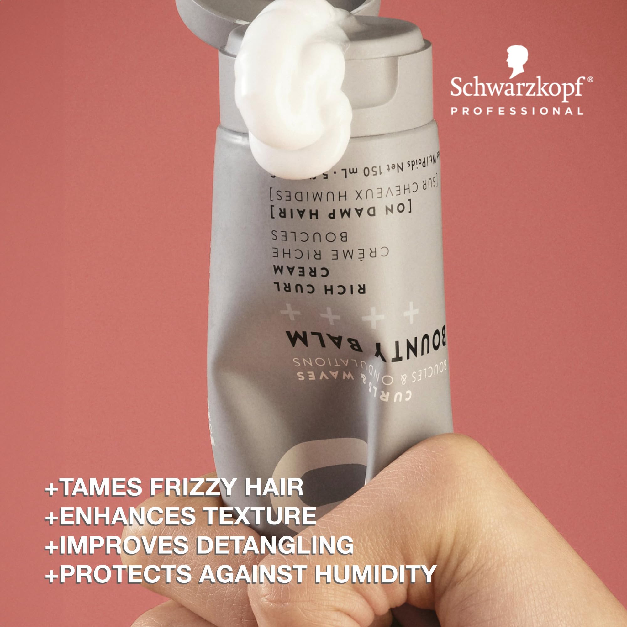 Hands applying OSiS+ Bounty Balm on damp hair for smoother detangling and texture