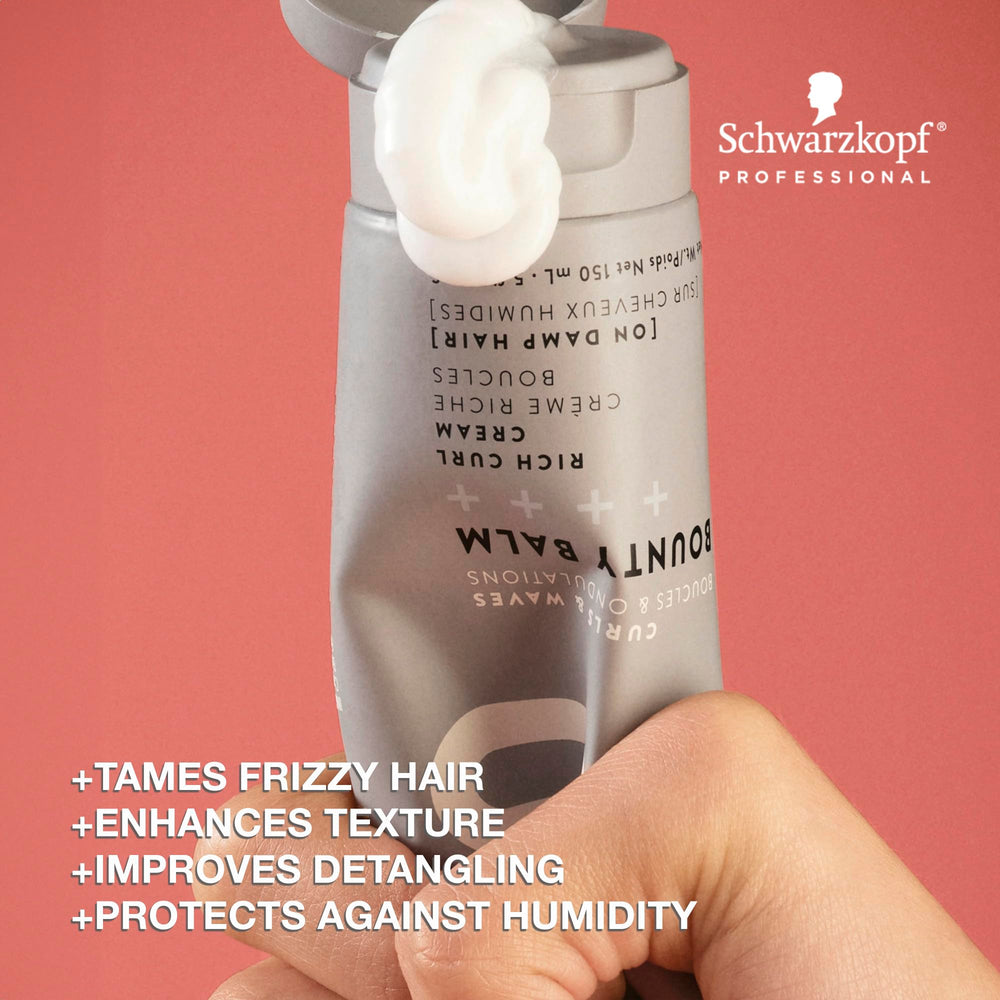 Hands applying OSiS+ Bounty Balm on damp hair for smoother detangling and texture