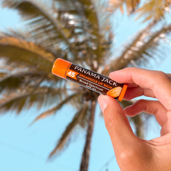 Applying Panama Jack lip balm on lips for smooth hydration.