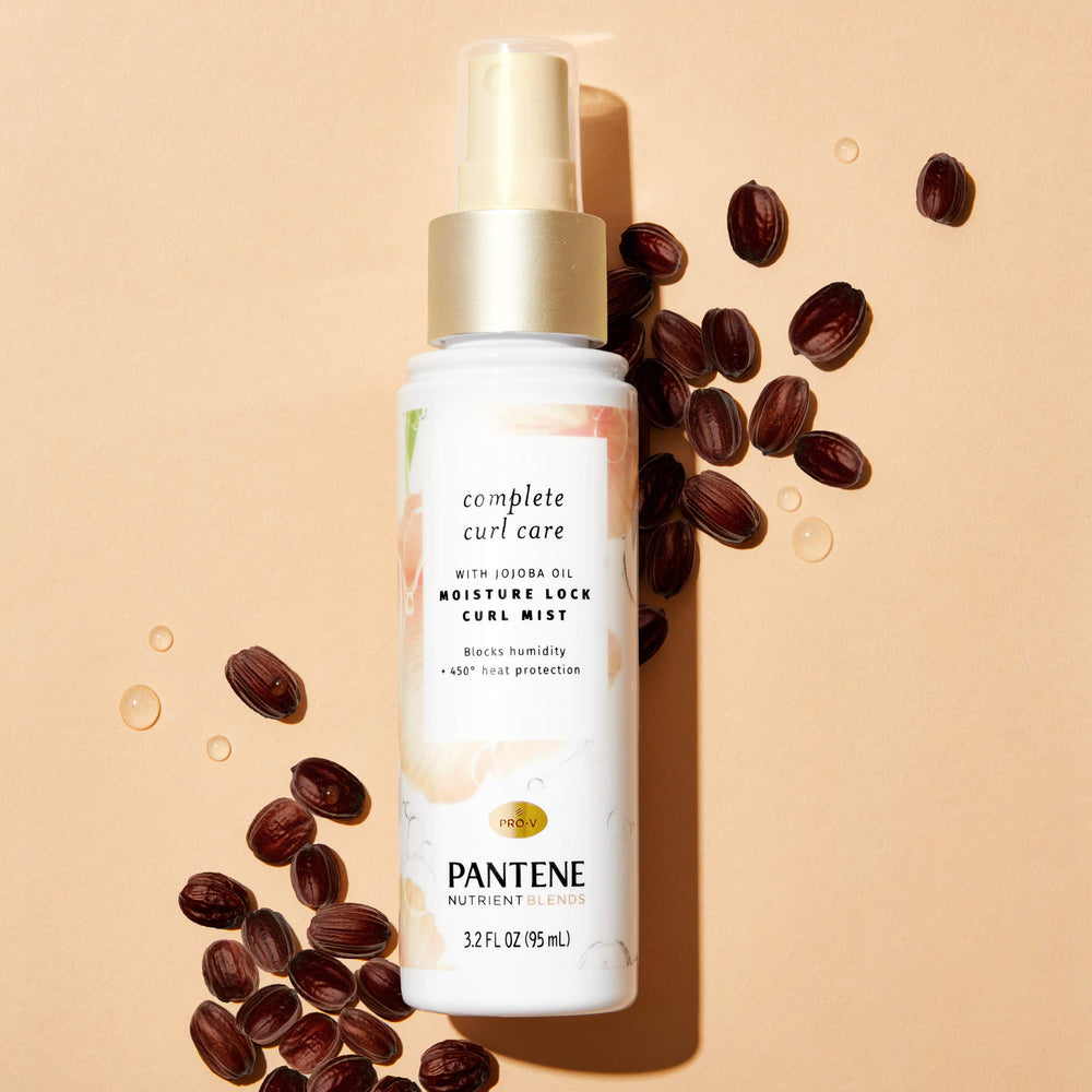 Pantene curling mist in use on styled curls, demonstrating detangling and frizz control.