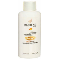 This image shows a Pantene Pro-V Moisture Renewal travel shampoo bottle on a dresser, travel-ready.