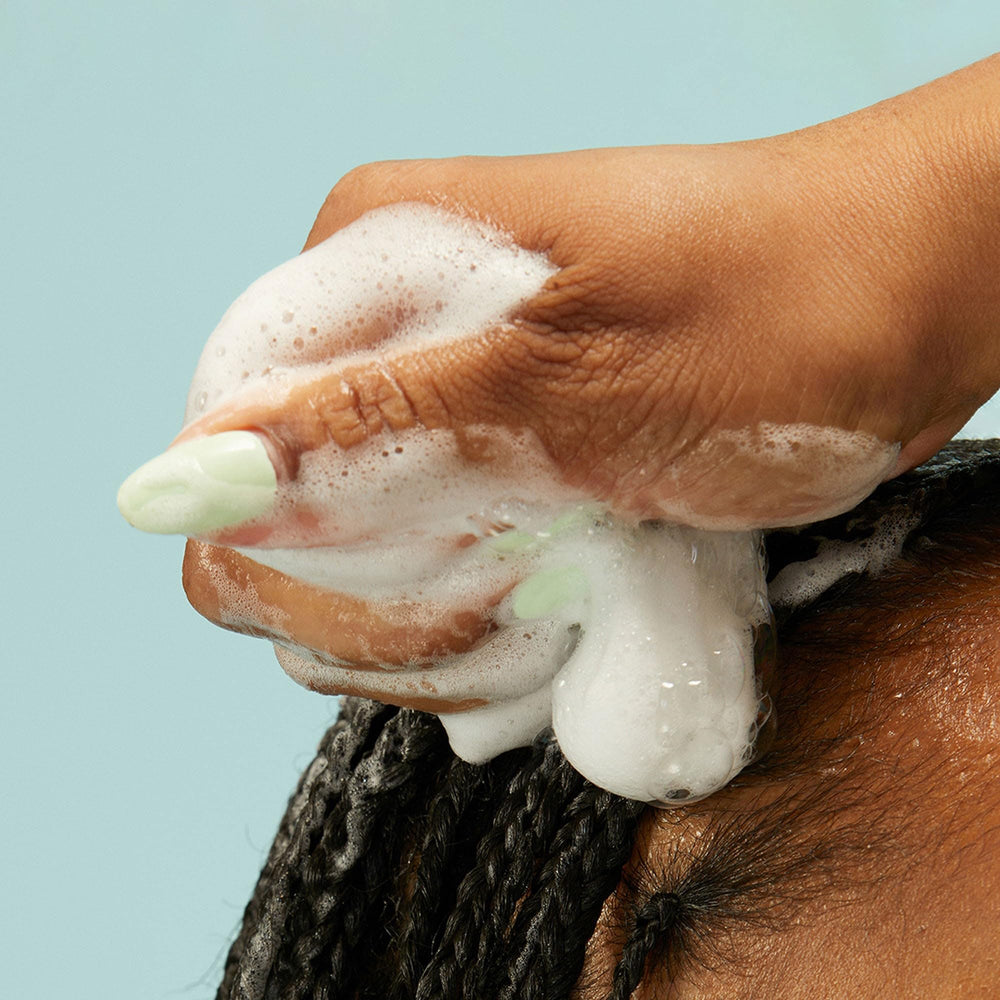 PATTERN Mousse in styled hair with voluminous shine.