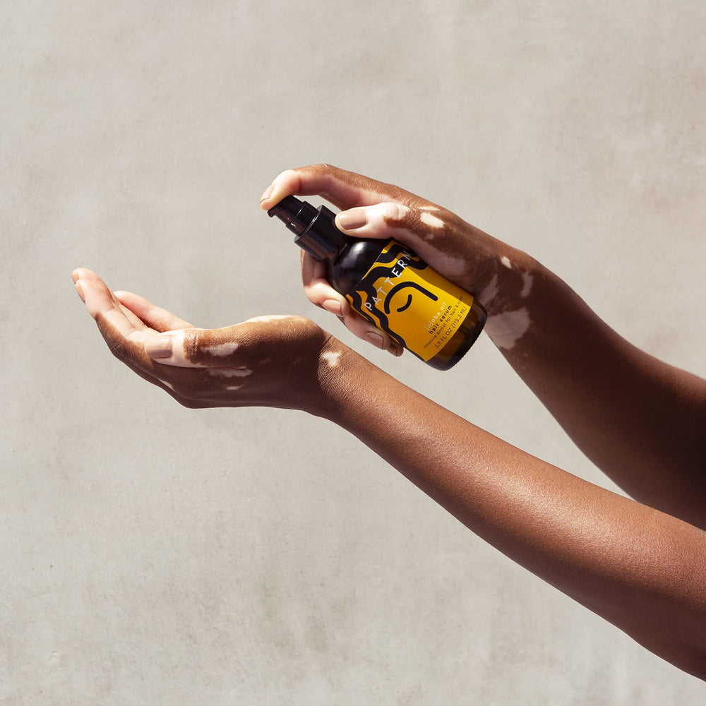 PATTERN Jojoba Hair Serum scalp massage visual suggests soothing care for the scalp.