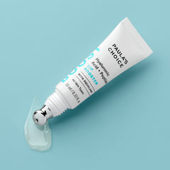 Paula's Choice Lip Booster on lips shows dewy finish and smooth texture.
