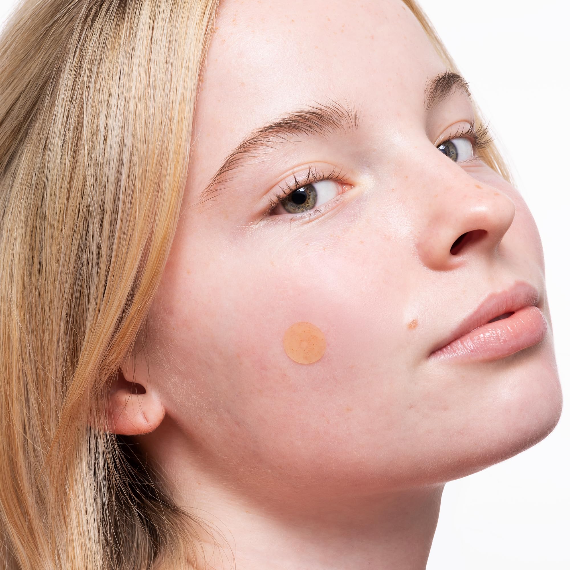 Peace Out Acne Healing Dots on finger showing patch size for easy application.