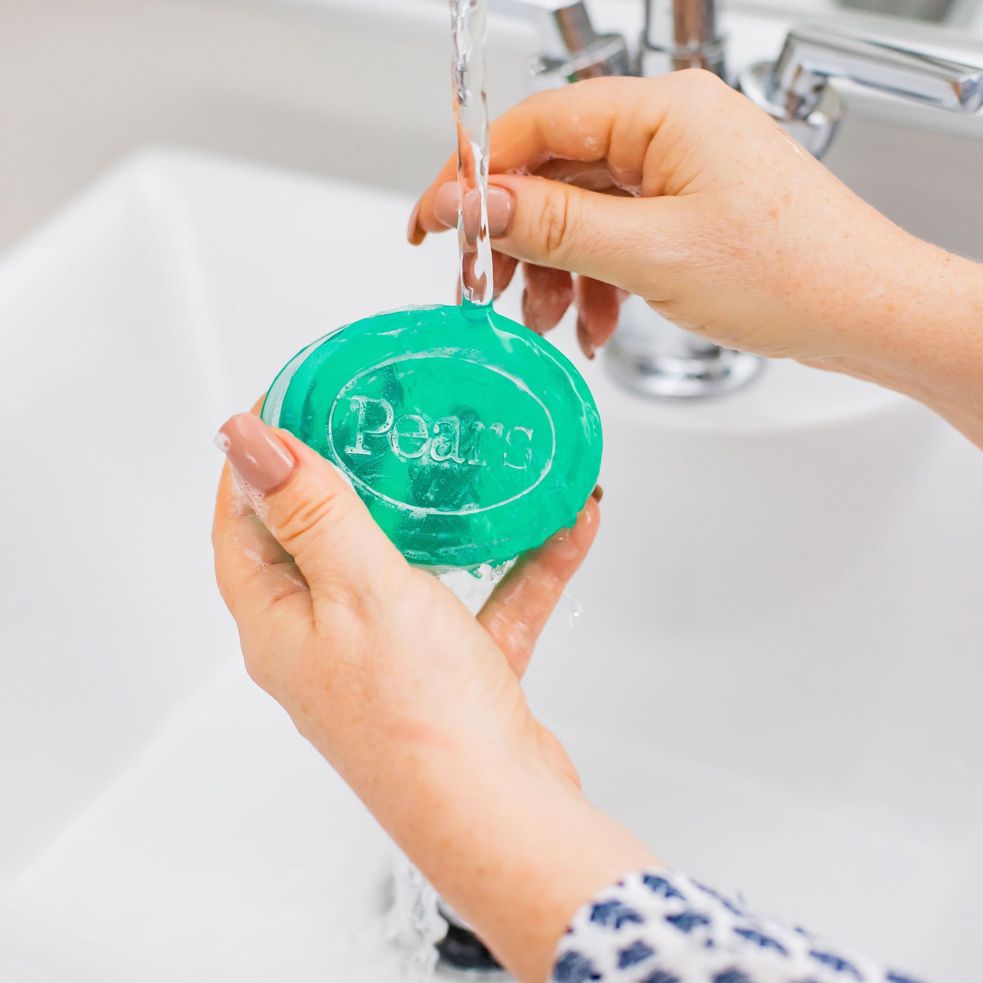 Hands lather Pears soap for gentle cleansing and moisturized skin.
