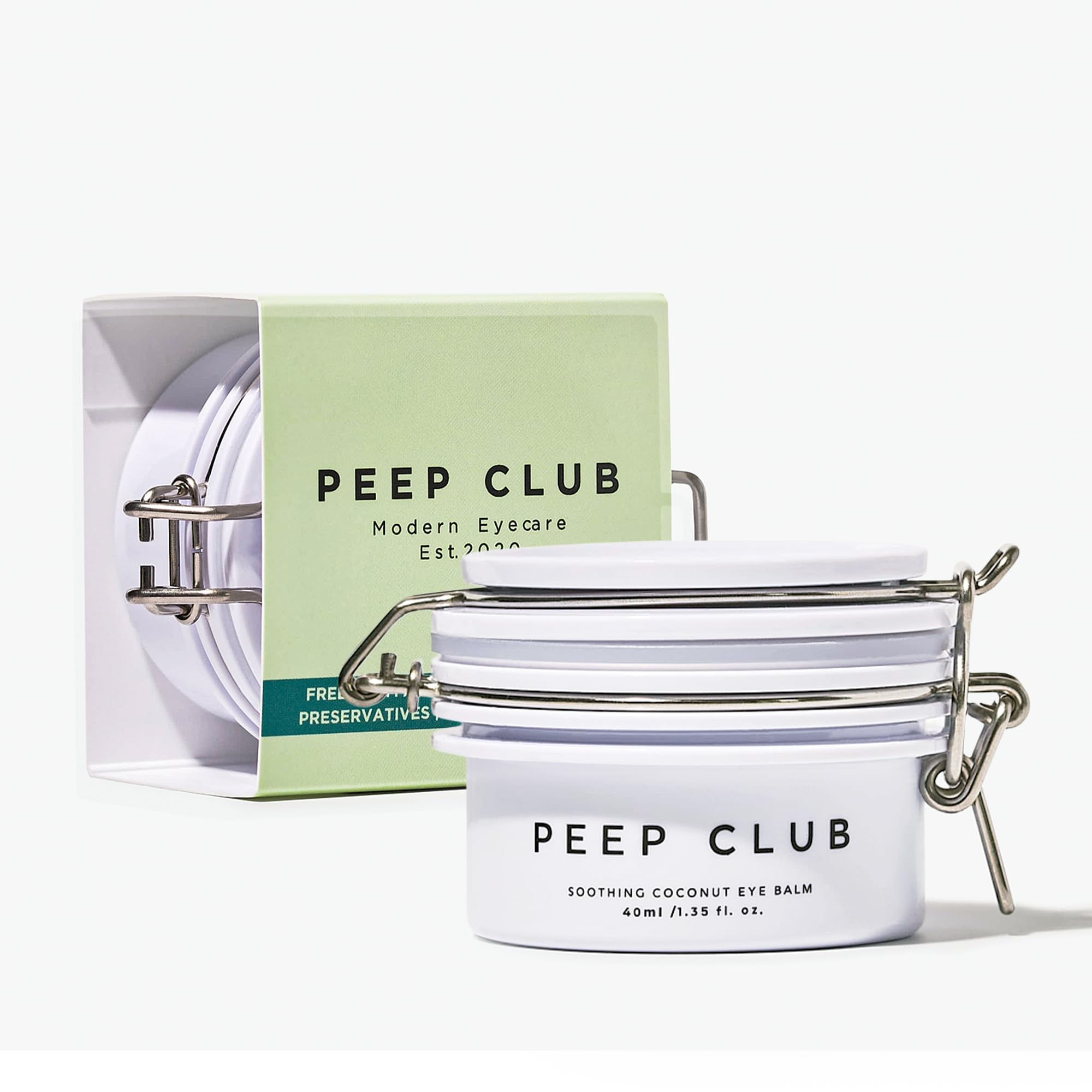 Peep Club Soothing Coconut Eye Balm packaging closeup for travel-friendly hydration.