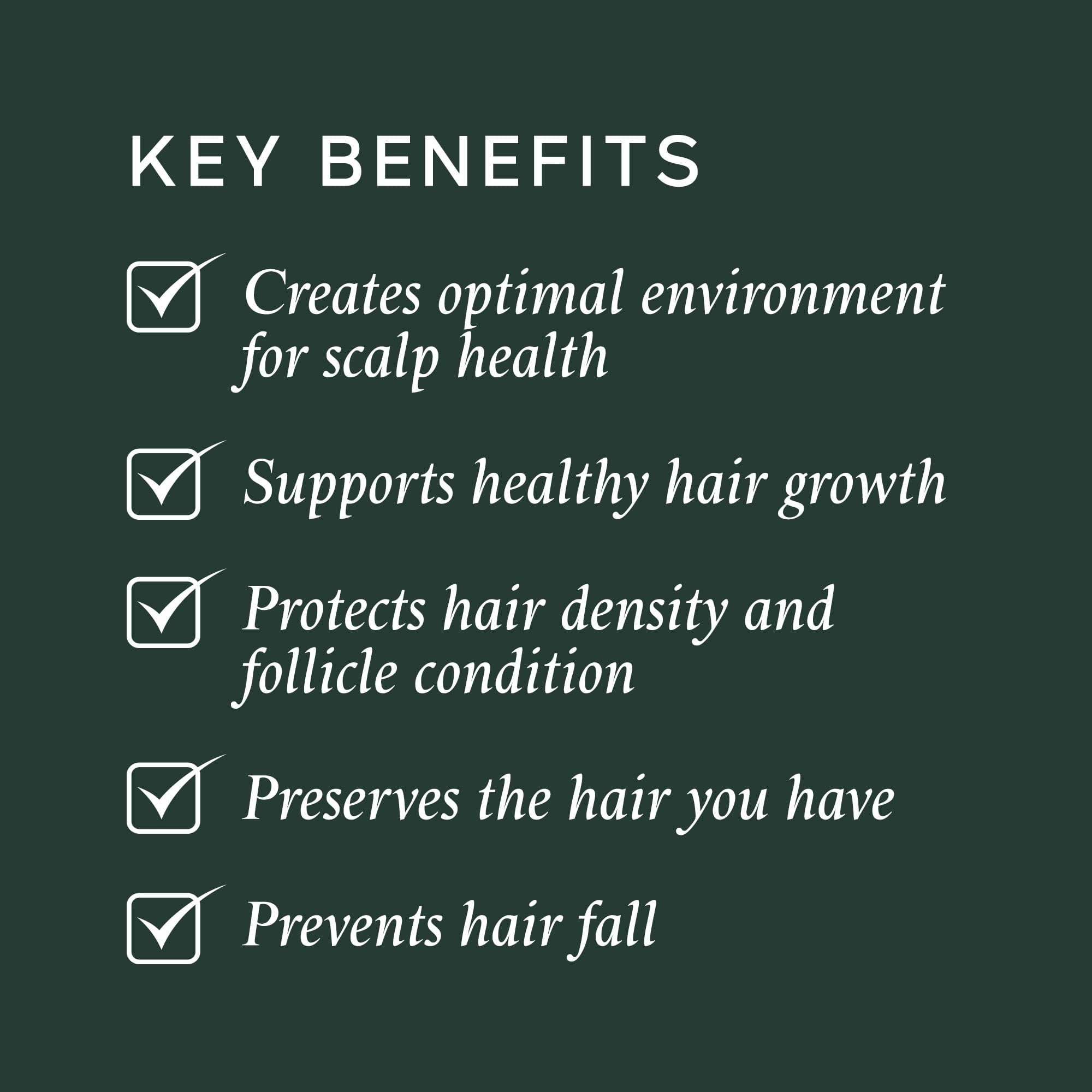 Applying Philip Kingsley Density Preserving Serum to the scalp for healthier follicles.