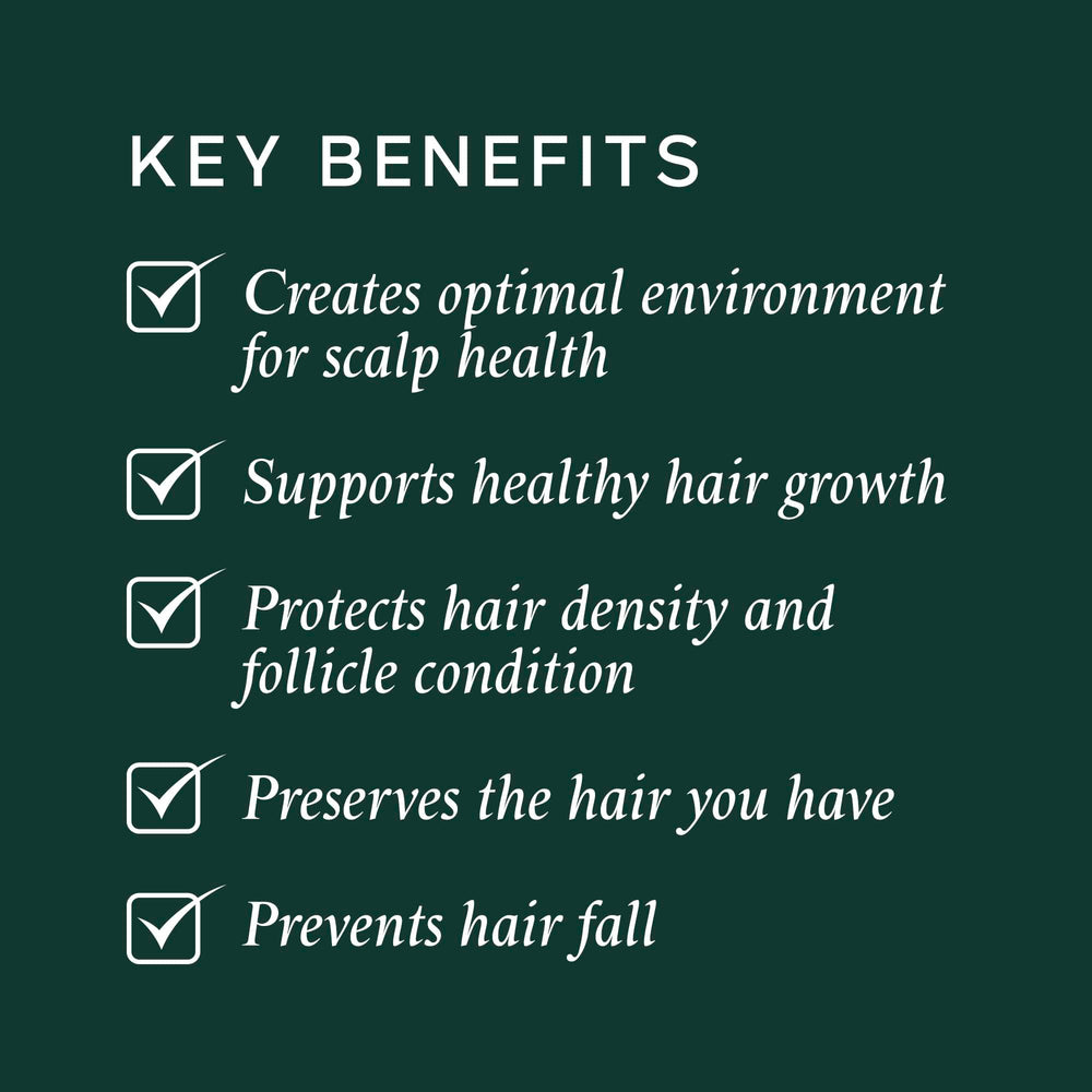 Applying Philip Kingsley Density Preserving Serum to the scalp for healthier follicles.