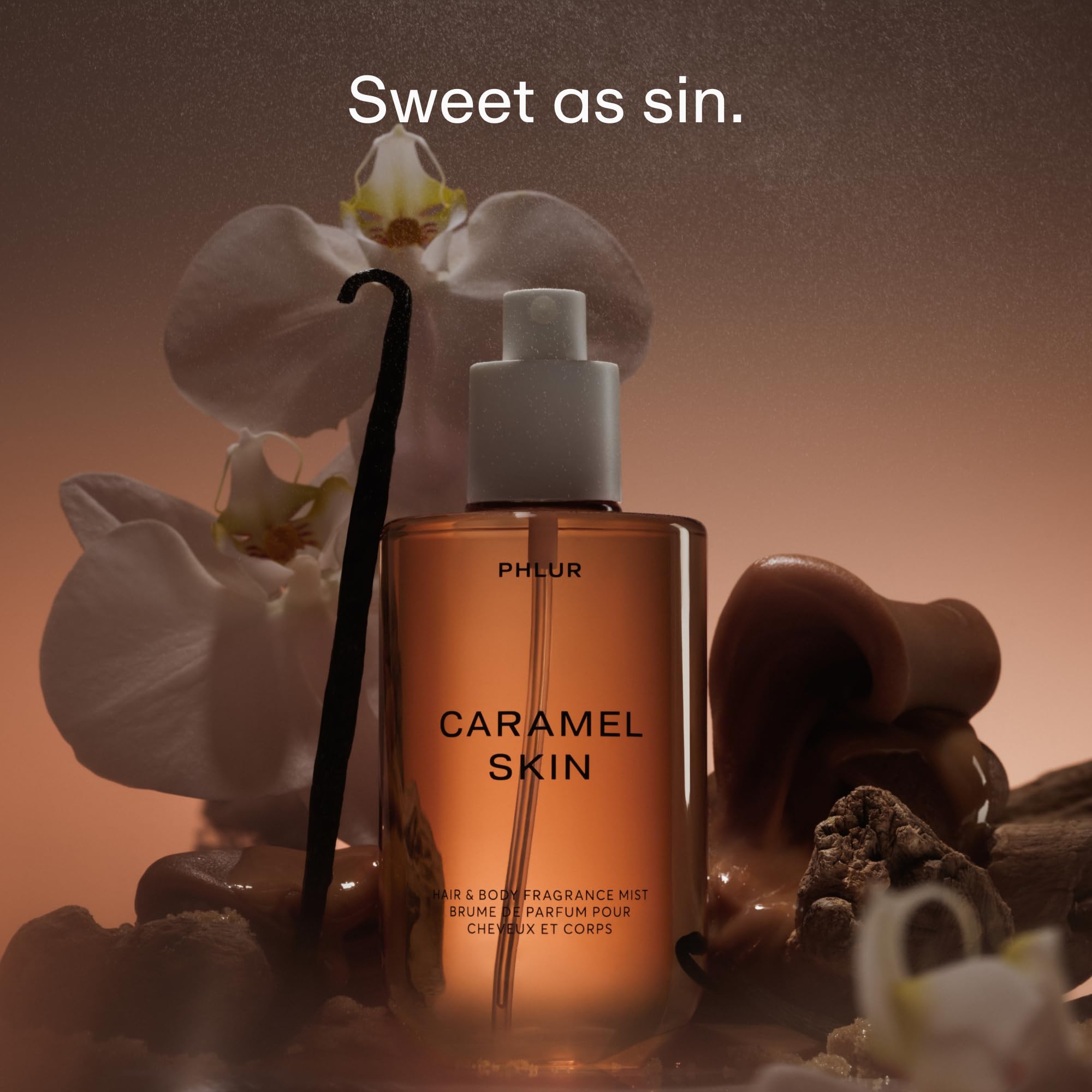 PHLUR Caramel Skin mist being sprayed, ready for all-over wear.