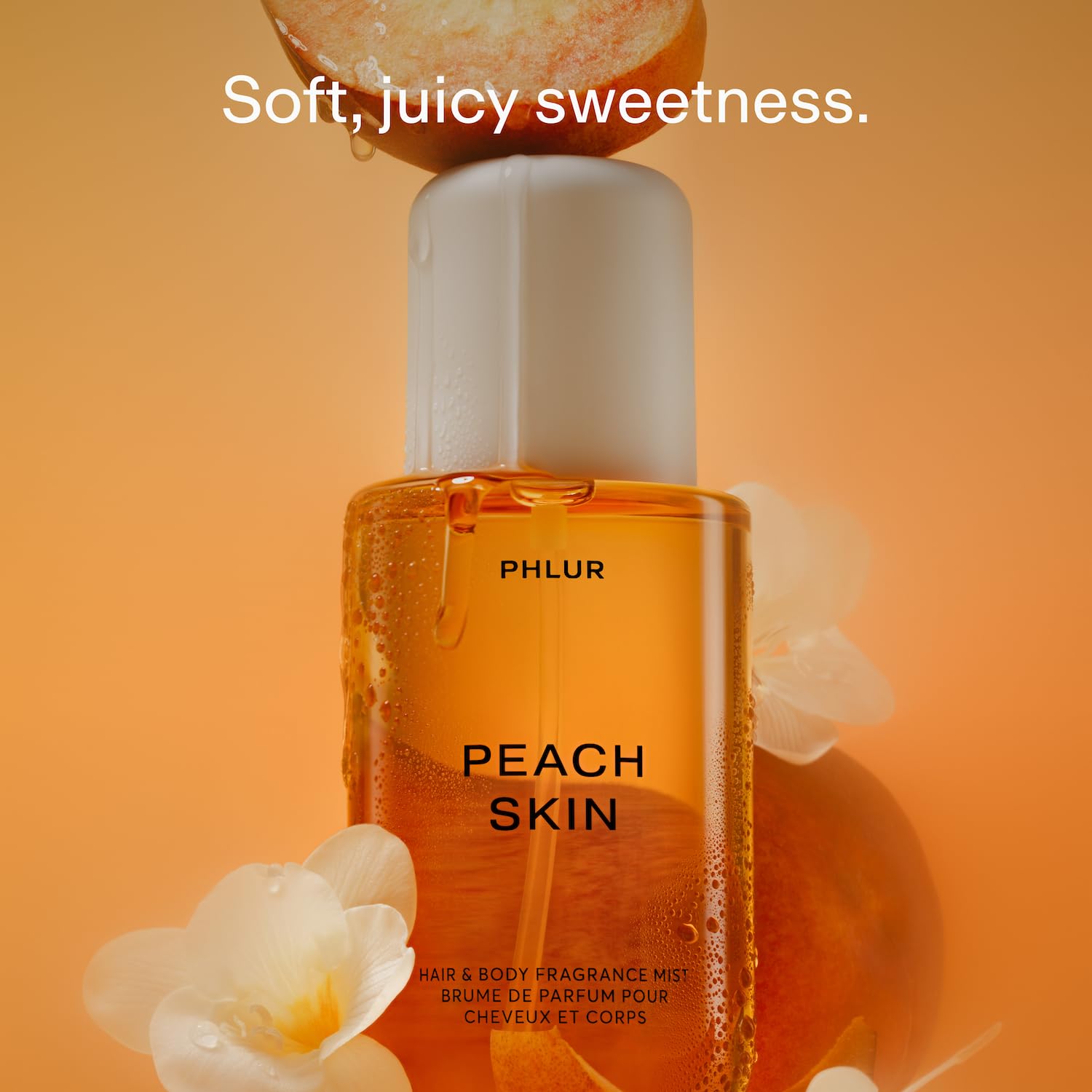 PHLUR Peach Skin Body Mist spray action for even distribution.
