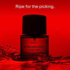 PHLUR Strawberry Letter cap closeup showing the magnetic lid for a premium feel