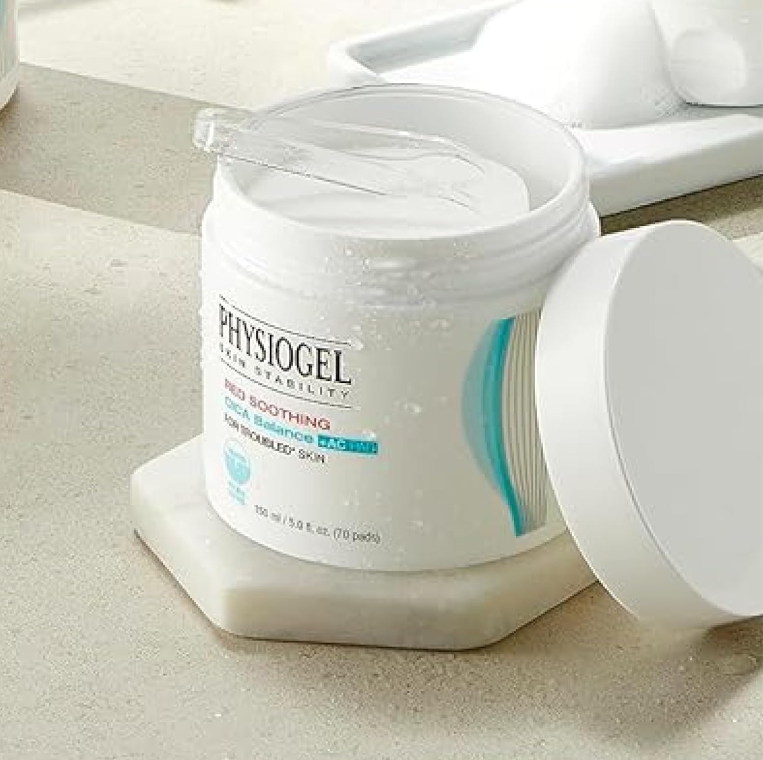 PHYSIOGEL Red Soothing Cica Balance Pad – applying on face for balanced hydration.
