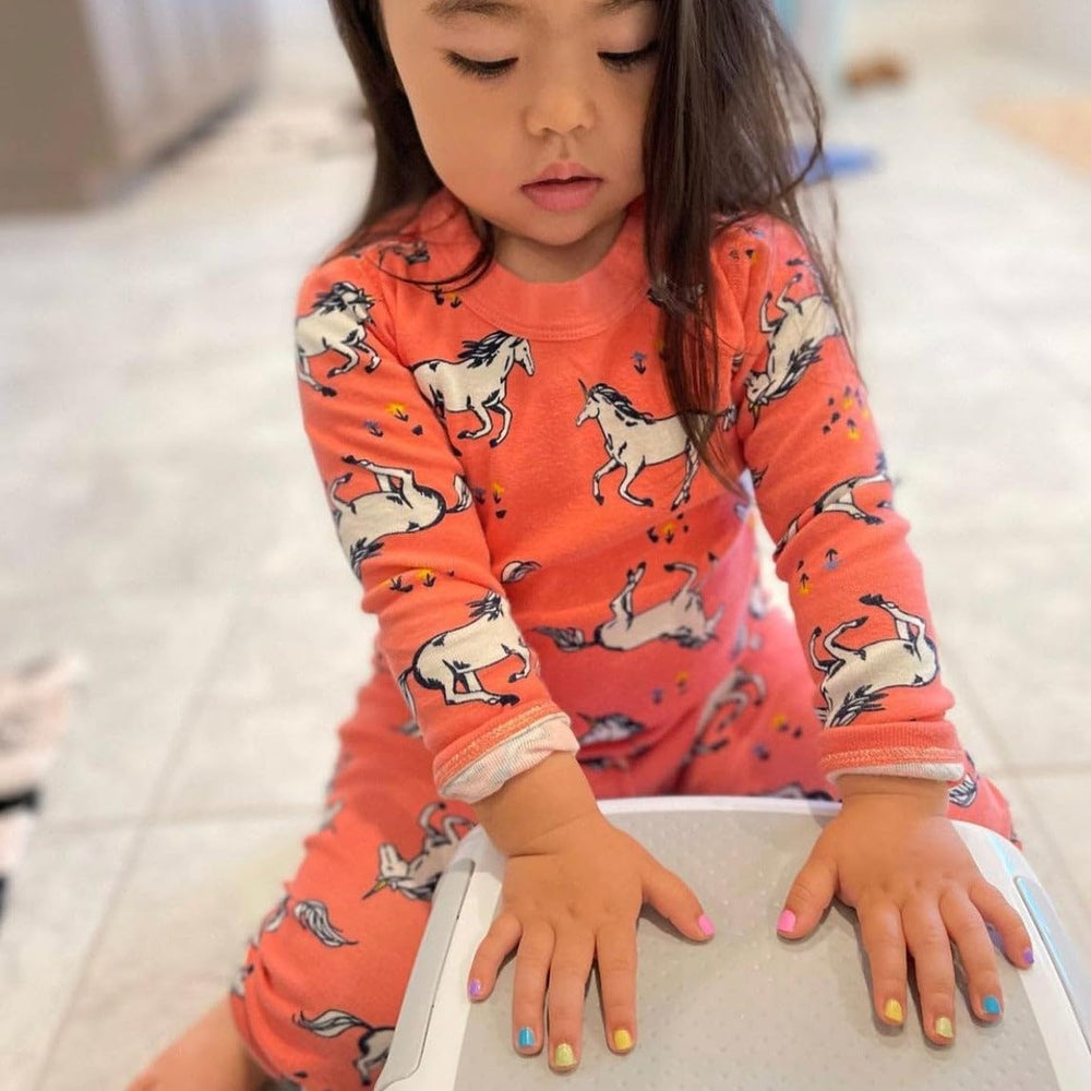 Child hands with yellow nails showing bright finish.