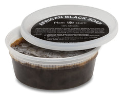 Close-up of Plant Guru African Black Soap Paste bar showing traditional texture.