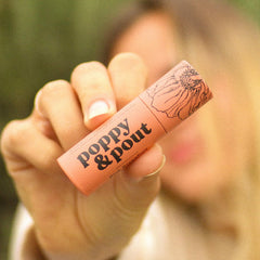 Poppy & Pout recyclable cardboard tube packaging on display.