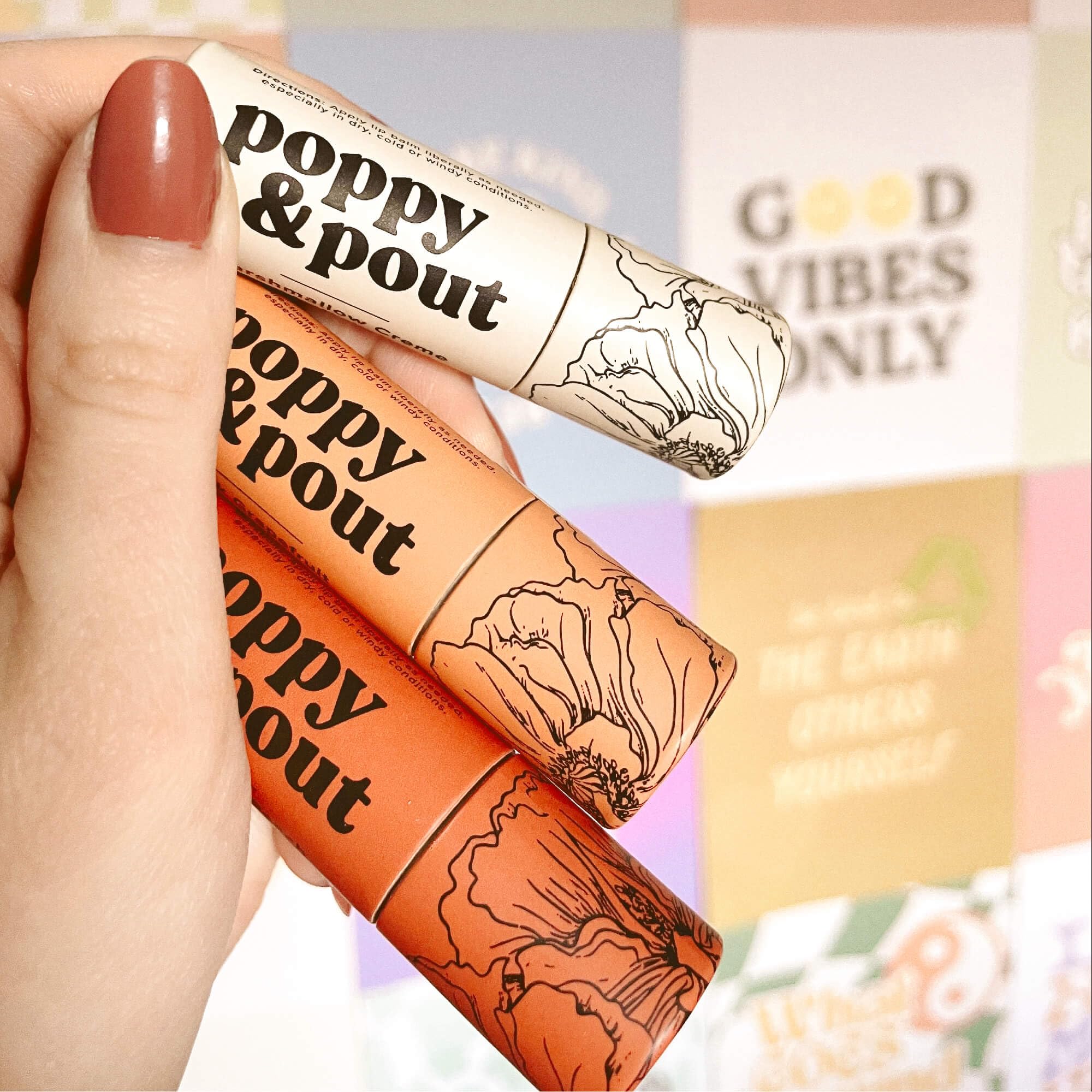 Poppy & Pout balm in a makeup bag for on-the-go moisture.
