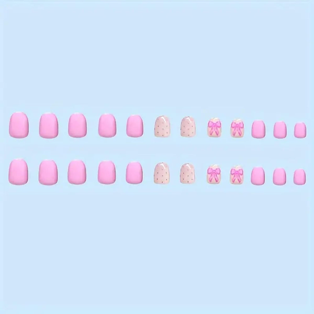 Powpop pink bow-knot nails close-up for a cute Valentine’s Day look.