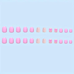 Powpop pink bow-knot nails close-up for a cute Valentine’s Day look.