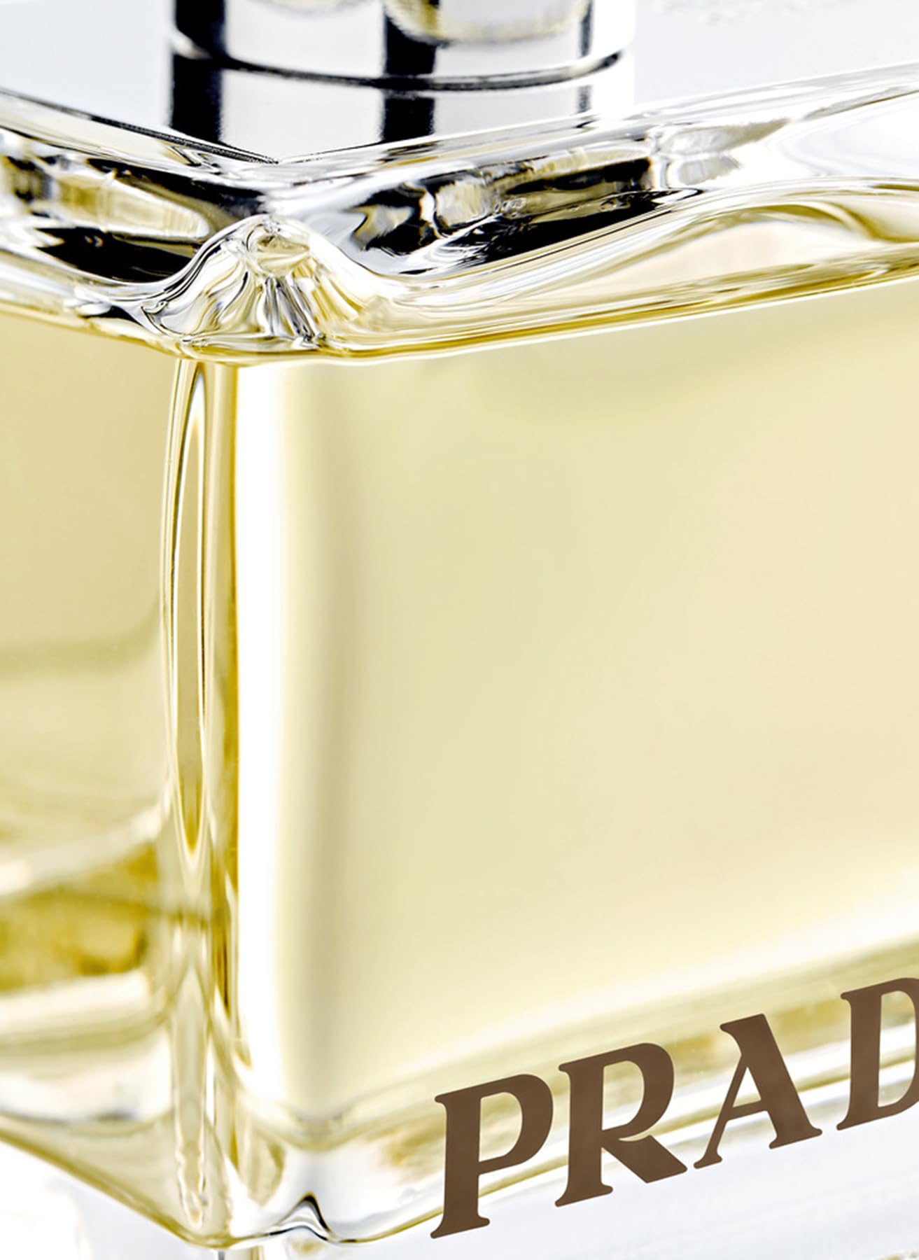 Prada Amber EdP elegant packaging with textured glass close-up for premium appeal.