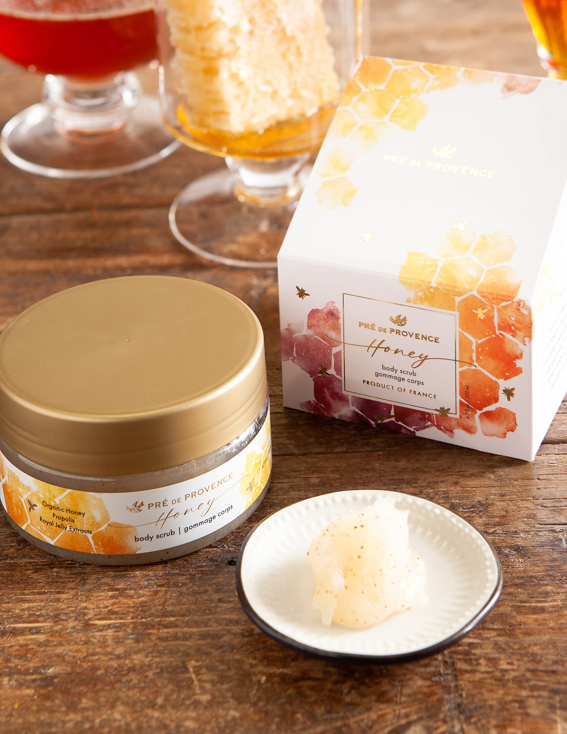 Hands applying scrub on damp skin in a pampering routine.