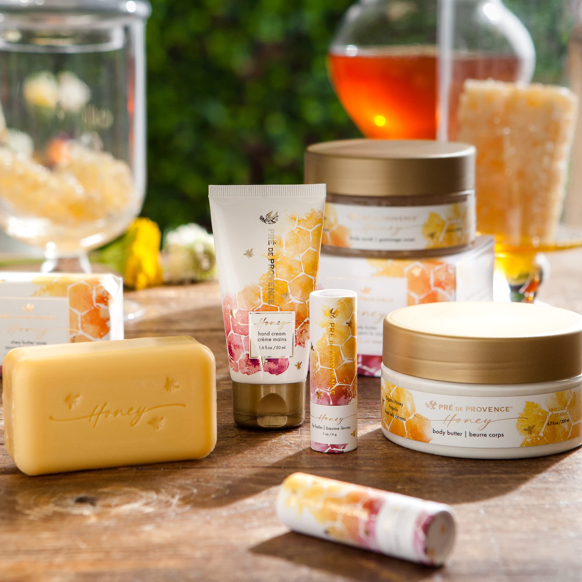 Packaging of the Pre de Provence Honey Collection on a Provençal shelf.