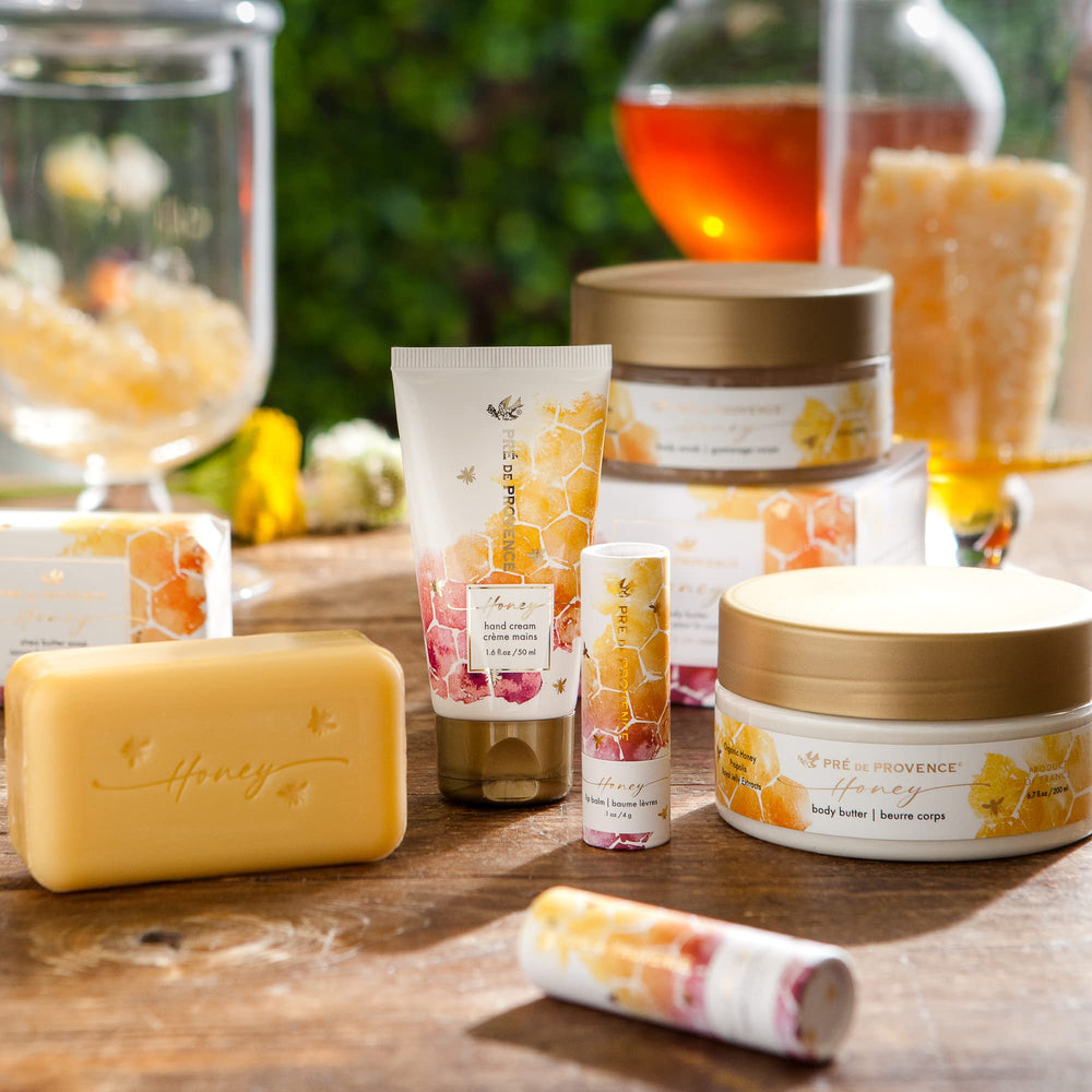 Packaging of the Pre de Provence Honey Collection on a Provençal shelf.