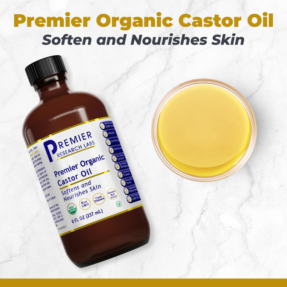 Premier Research Labs cold-pressed castor oil bottle on vanity for hair nourishment.