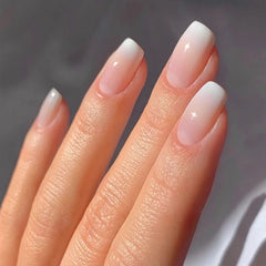 Qsnidy press-on nail kit contents include file, stick, alcohol pad, and glue for at-home manicure.