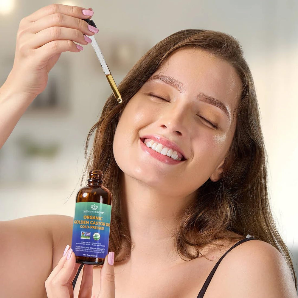 QUEEN OF THE THRONES golden castor oil on natural-light backdrop highlights quality for skin.