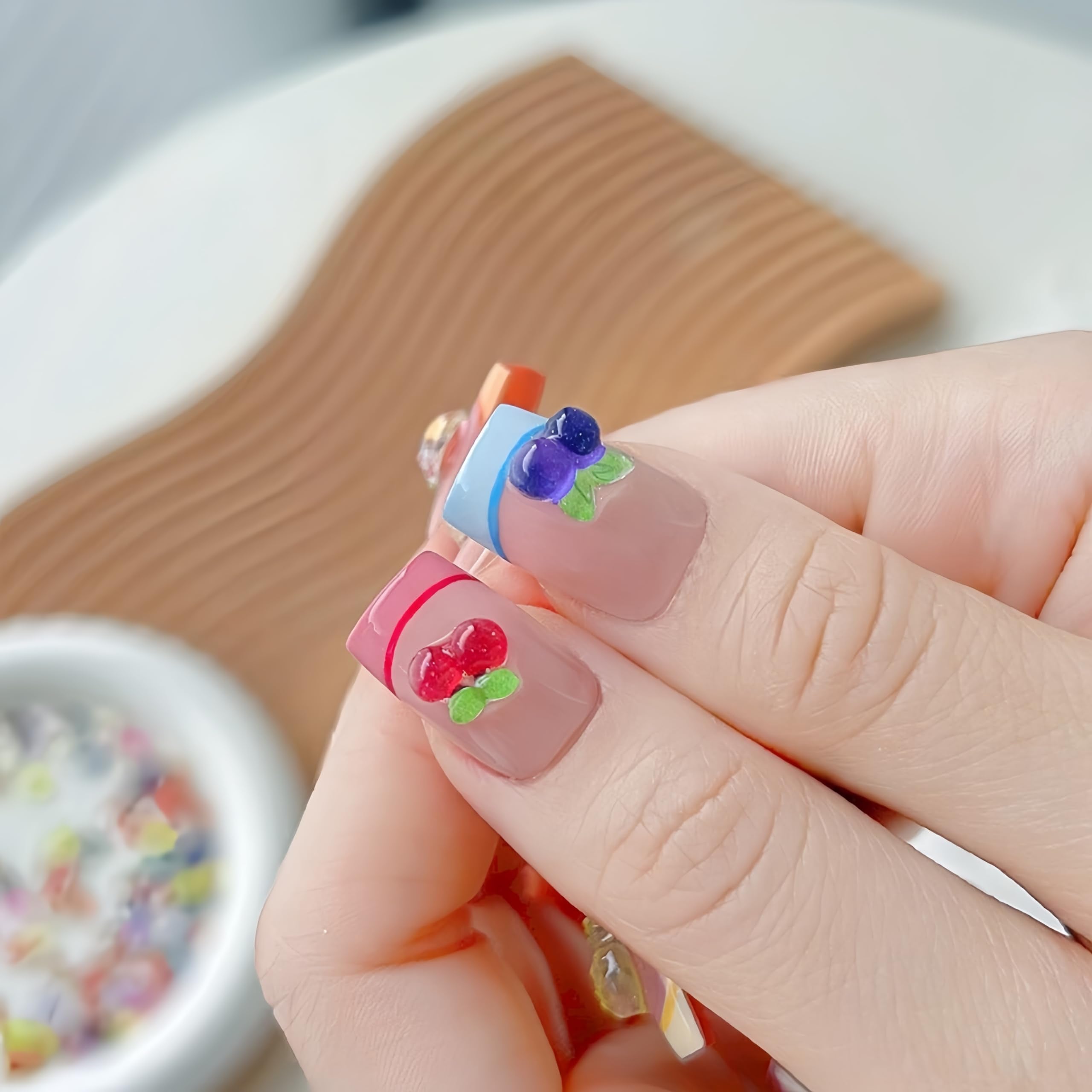 Quezadyl 3D apple nail charms offer glossy fruit accents for DIY nails.