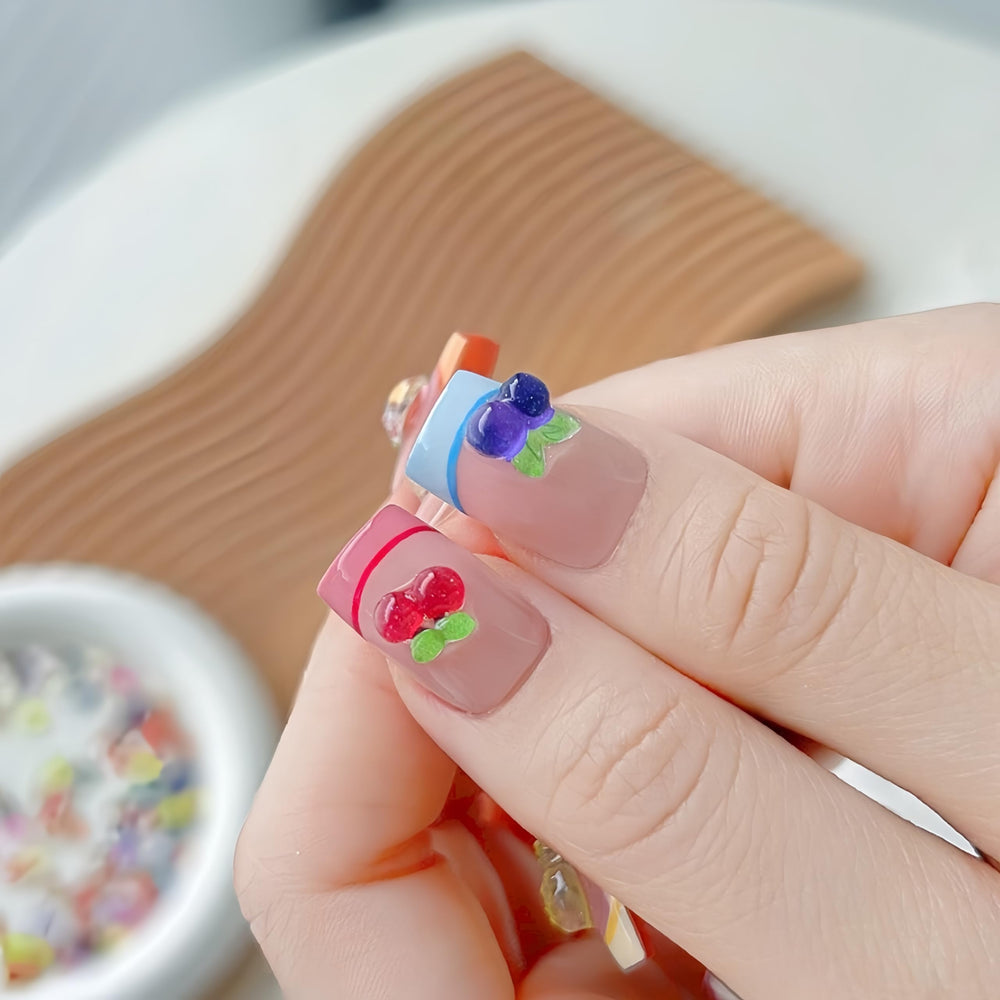 Quezadyl 3D apple nail charms offer glossy fruit accents for DIY nails.