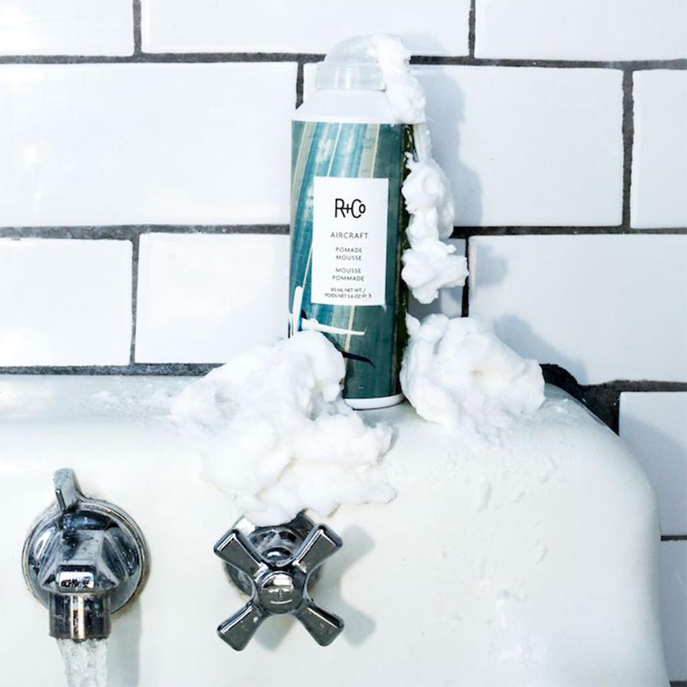 R+CO Aircraft Pomade Mousse includes neem oil for moisture and strength.