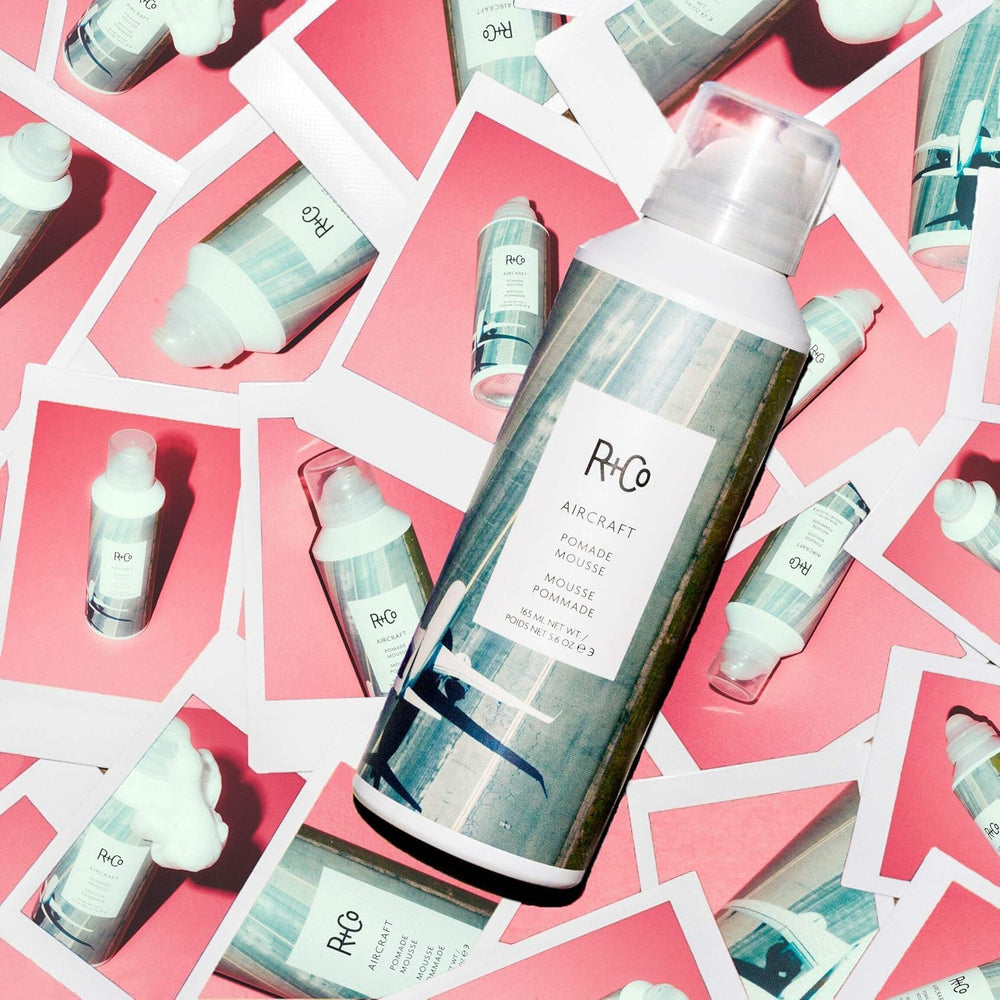 R+CO Aircraft Pomade Mousse bottle highlights heat protection during styling.