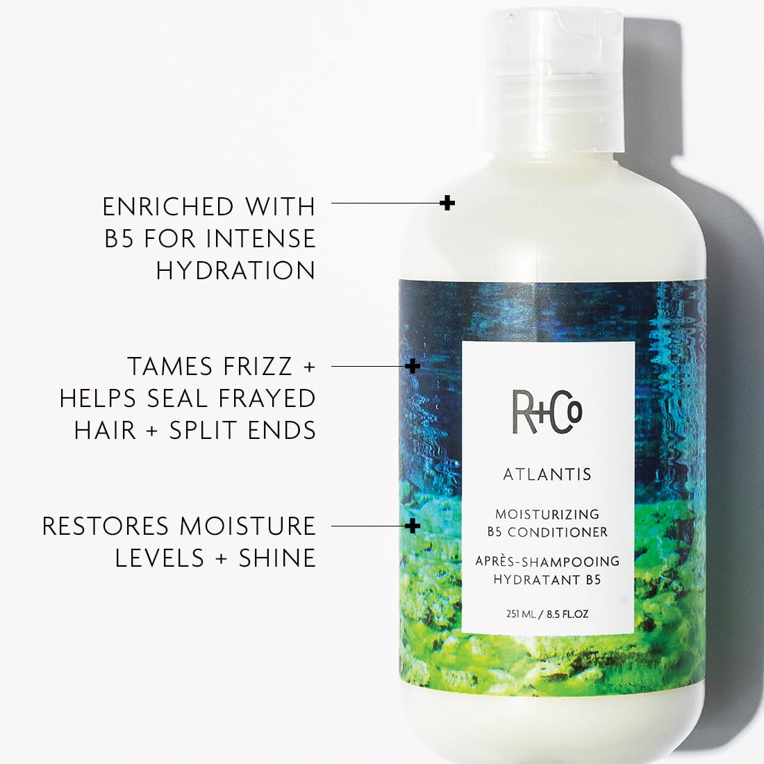 Applying R+Co Atlantis conditioner to hair to improve moisture and manageability.