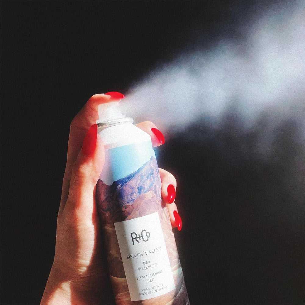 R+Co Death Valley dry shampoo packaging highlights a compact canister for on-the-go refresh.