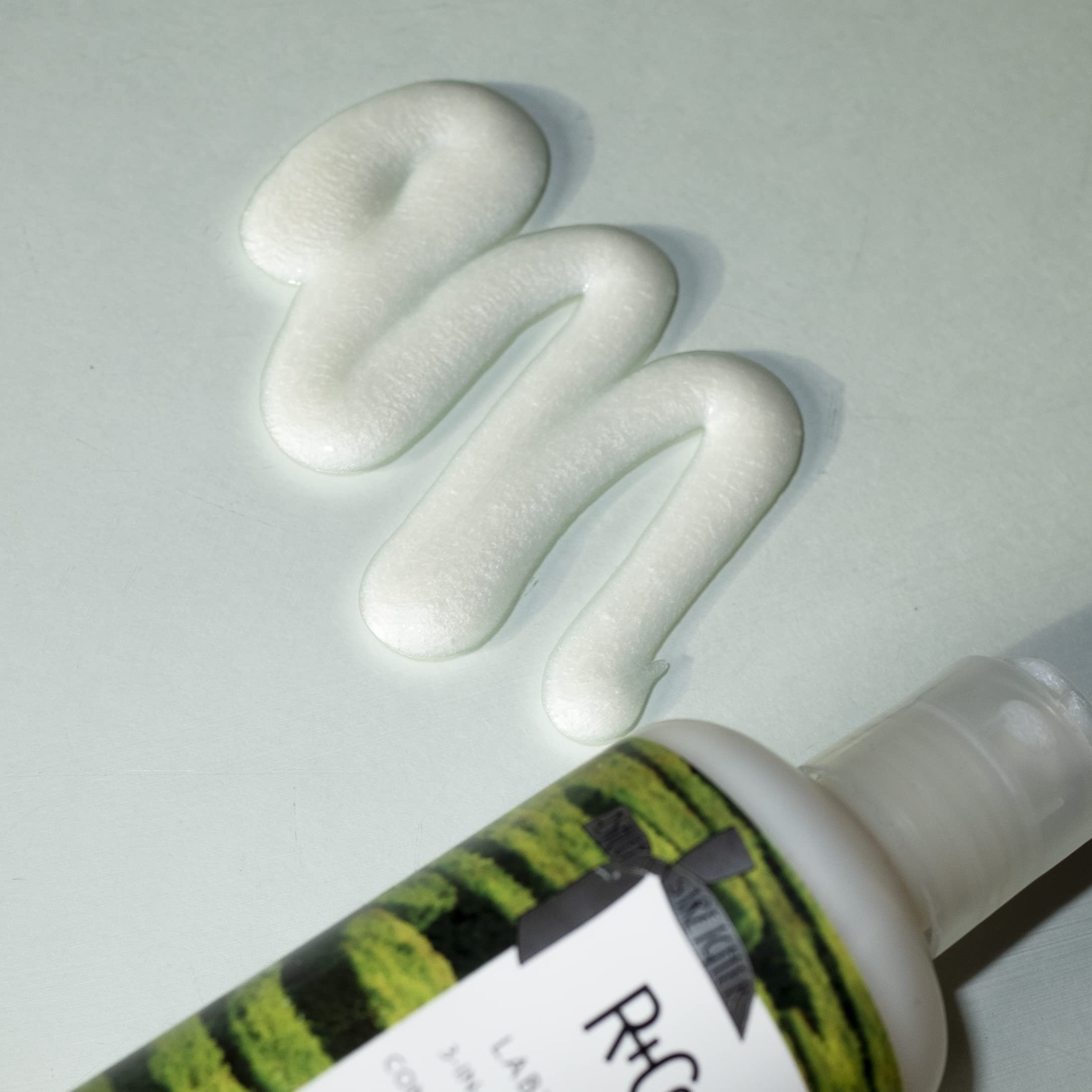 R+Co Labyrinth shampoo lather closeup shows gentle cleansing for a fresh, textured look.