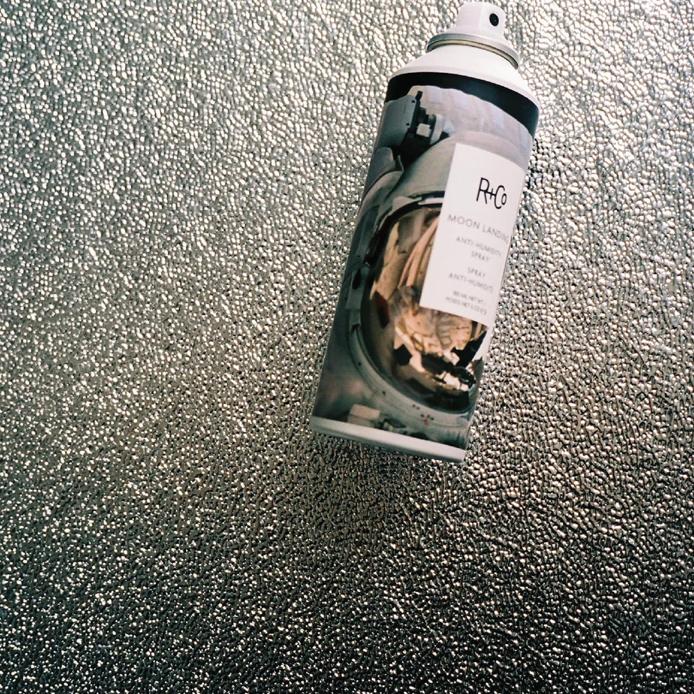 R+Co Moon Landing spray on hair for added shine and moisture.